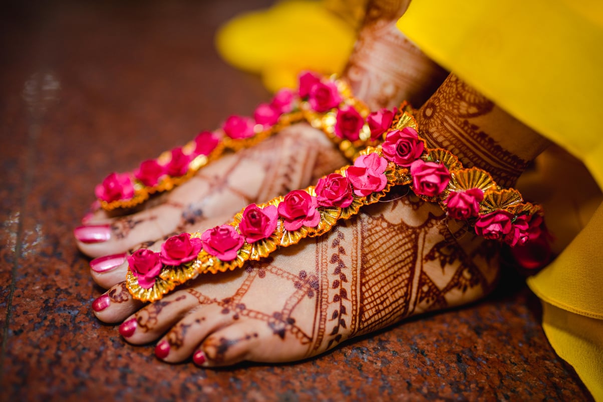 Feet of Person with Tattoo and Floral Decoration